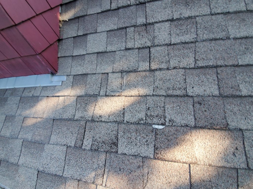 close up of shingles before roof replacement by evanston roofing contractor