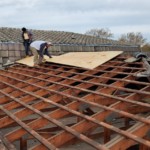 Northbrook roofing contractor shows wood framing under concrete tiled roof