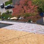 Orland Park roofing contractors tied off while working